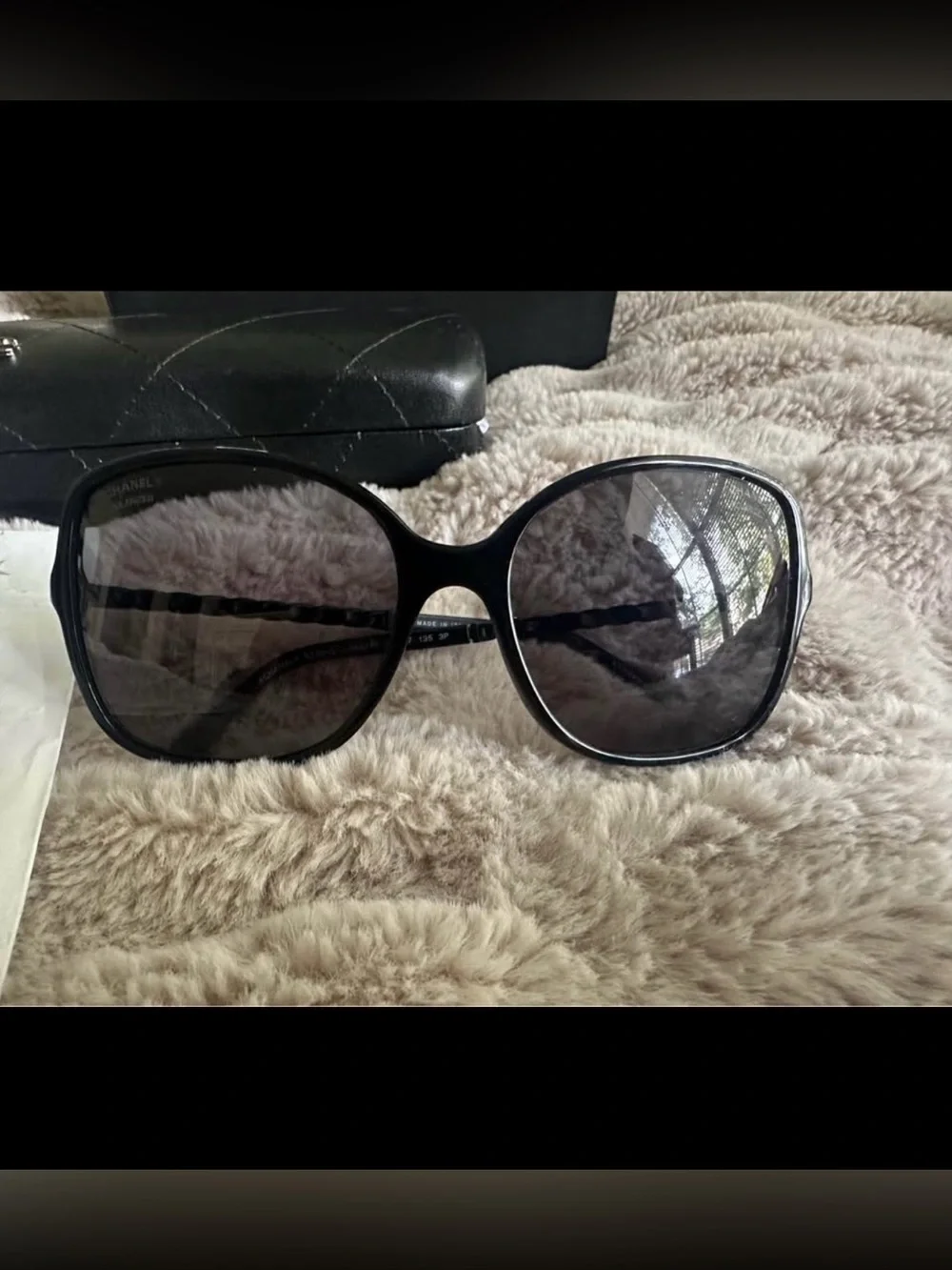 Beautiful oversized black CHANEL sunglasses with dark lenses.